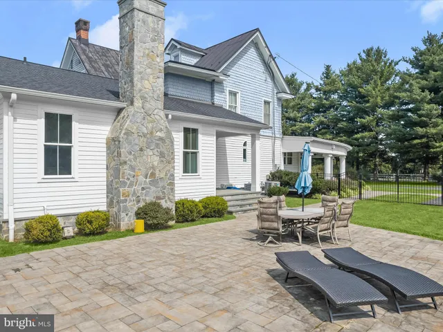 a view of a green field with trees in the background
