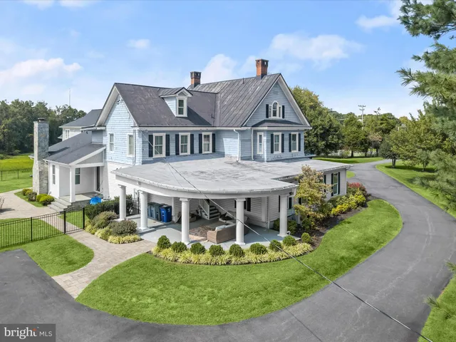 a view of a grassy field with trees in the background