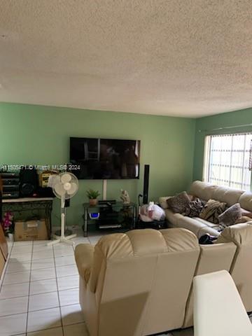 11861 Southwest 18th Street, Unit 329 Miami, FL 33175 - Photo 3 of 23 a bedroom with furniture and a flat screen tv