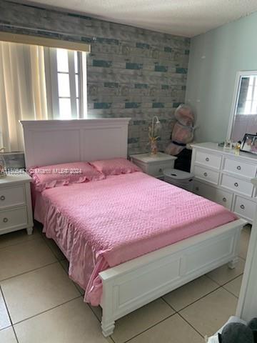 11861 Southwest 18th Street, Unit 329 Miami, FL 33175 - Photo 8 of 23 a bedroom with a bed and a window