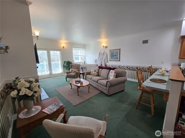 a living room with furniture fireplace and a table
