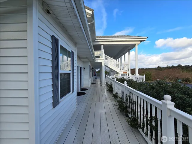 a view of a balcony with wooden floor and stairs