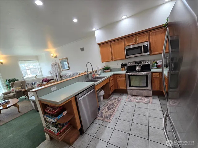 a kitchen with stainless steel appliances granite countertop a sink and a stove