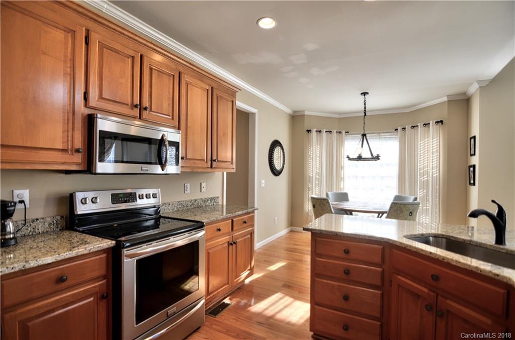 10435 Blackstock Road Huntersville, NC 28078 - Photo 11 of 33 a kitchen with stainless steel appliances granite countertop a stove a sink and a microwave