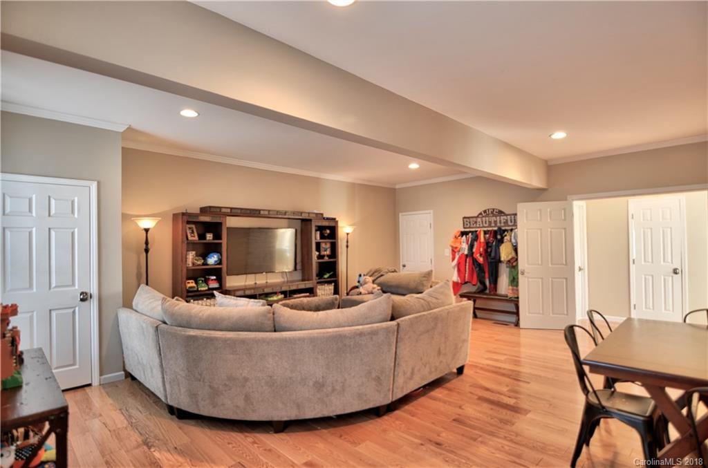 10435 Blackstock Road Huntersville, NC 28078 - Photo 17 of 33 a living room with furniture and a flat screen tv