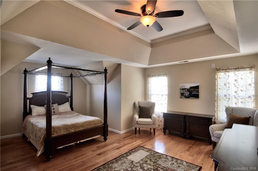 10435 Blackstock Road Huntersville, NC 28078 - Photo 20 of 33 a bedroom with a bed a couch and a potted plant on the dresser