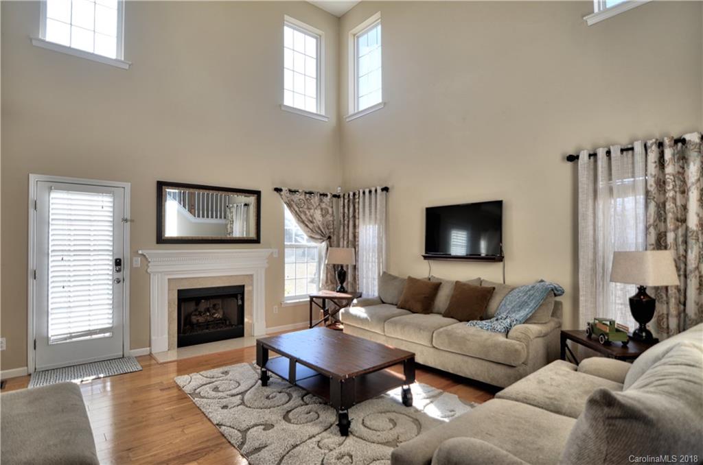 10435 Blackstock Road Huntersville, NC 28078 - Photo 3 of 33 a living room with furniture a flat screen tv and a fireplace