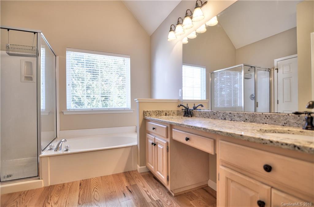 10435 Blackstock Road Huntersville, NC 28078 - Photo 23 of 33 a spacious bathroom with a granite countertop sink mirror and a bath tub