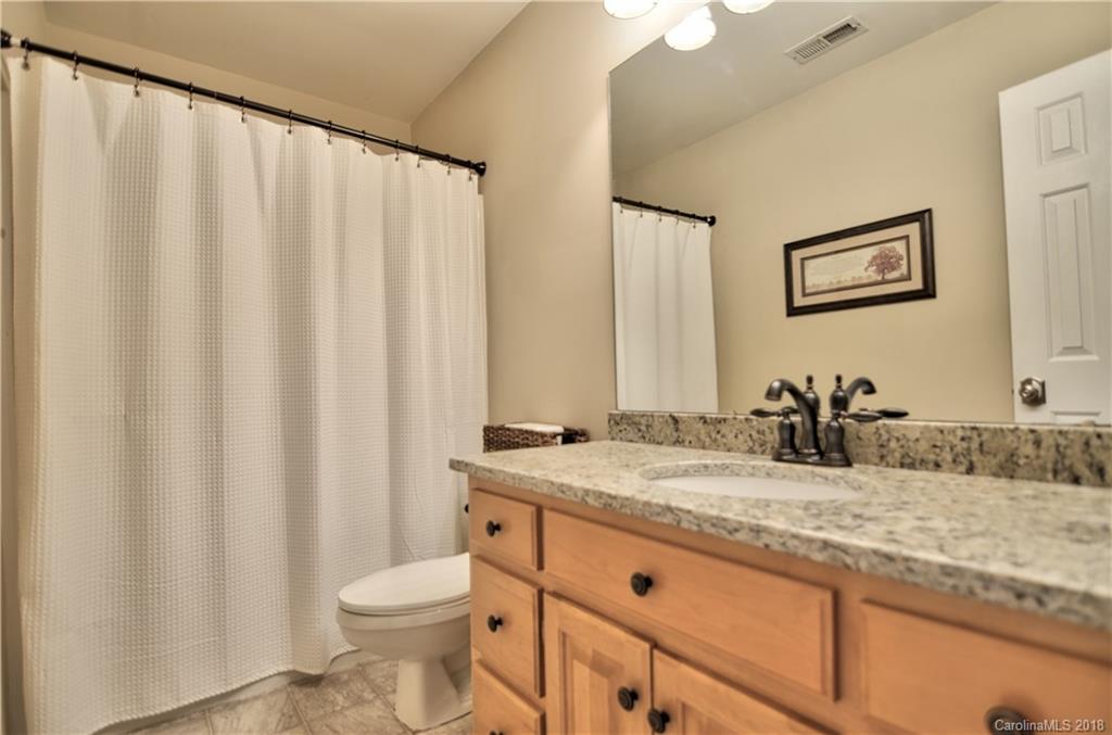 10435 Blackstock Road Huntersville, NC 28078 - Photo 27 of 33 a bathroom with a granite countertop sink and a mirror