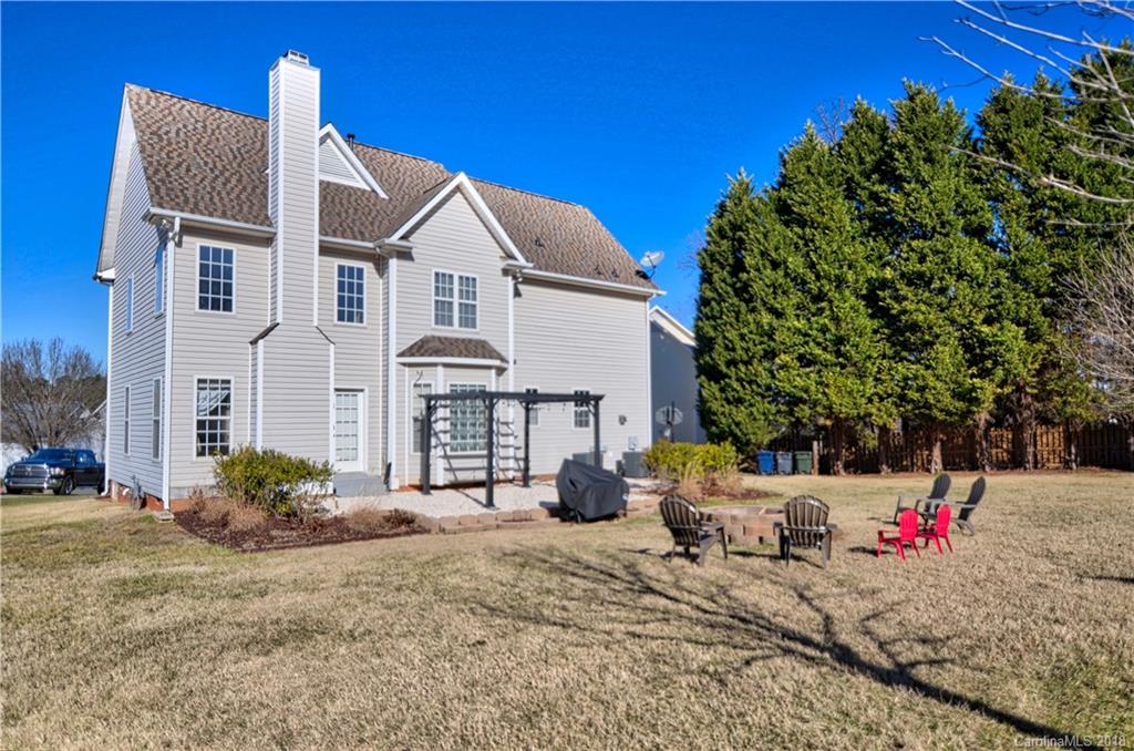 10435 Blackstock Road Huntersville, NC 28078 - Photo 28 of 33 a view of a white house with a yard and plants