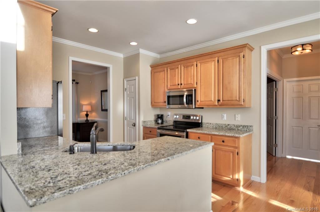 10435 Blackstock Road Huntersville, NC 28078 - Photo 10 of 33 a kitchen with stainless steel appliances granite countertop a sink stove and refrigerator