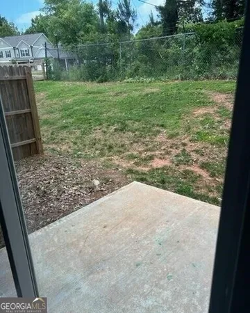 a backyard of a house with lots of green space and lake view