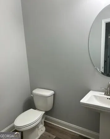 a white toilet sitting next to a bathroom sink