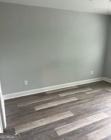 a view of a room with wooden floor