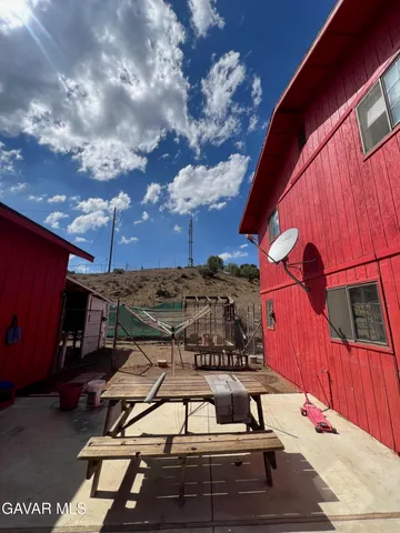 a view of a chairs and table in the backyard