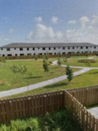 a view of a swimming pool with a yard