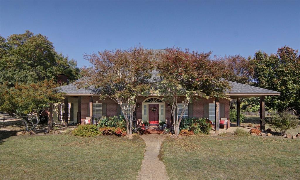 216 Sam Bass Road Willow Park, TX 76087 - Photo 2 of 34 Obstructed view of property with a front yard, a porch, brick siding, and roof with shingles