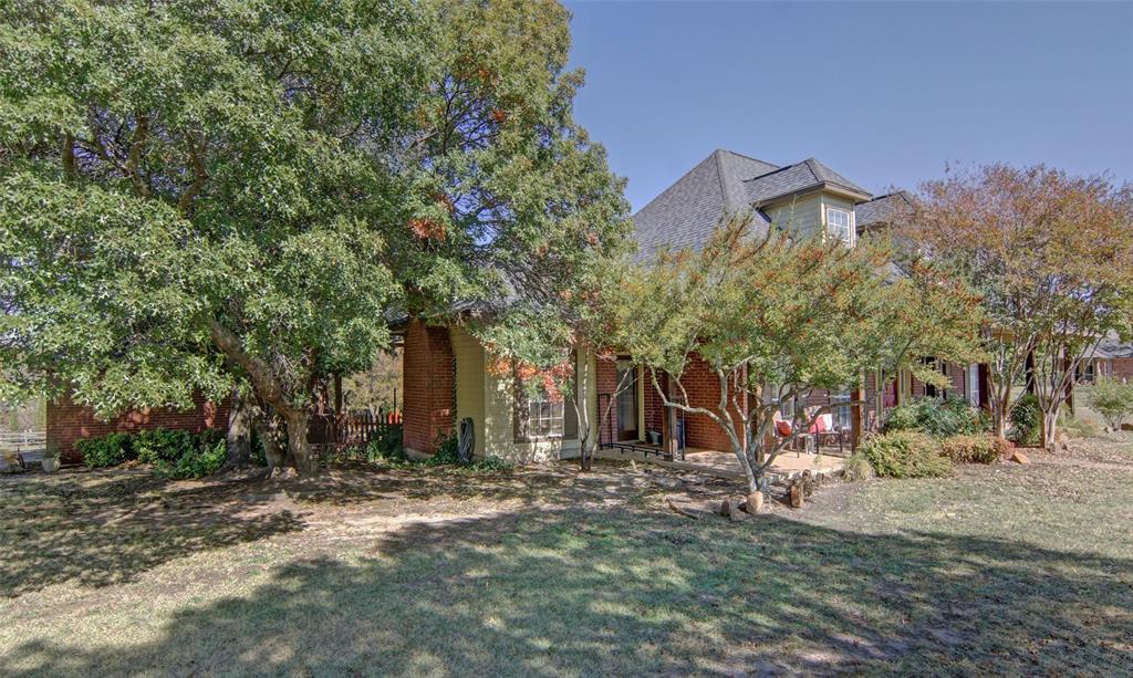 216 Sam Bass Road Willow Park, TX 76087 - Photo 3 of 34 View of property hidden behind natural elements with a front yard and roof with shingles