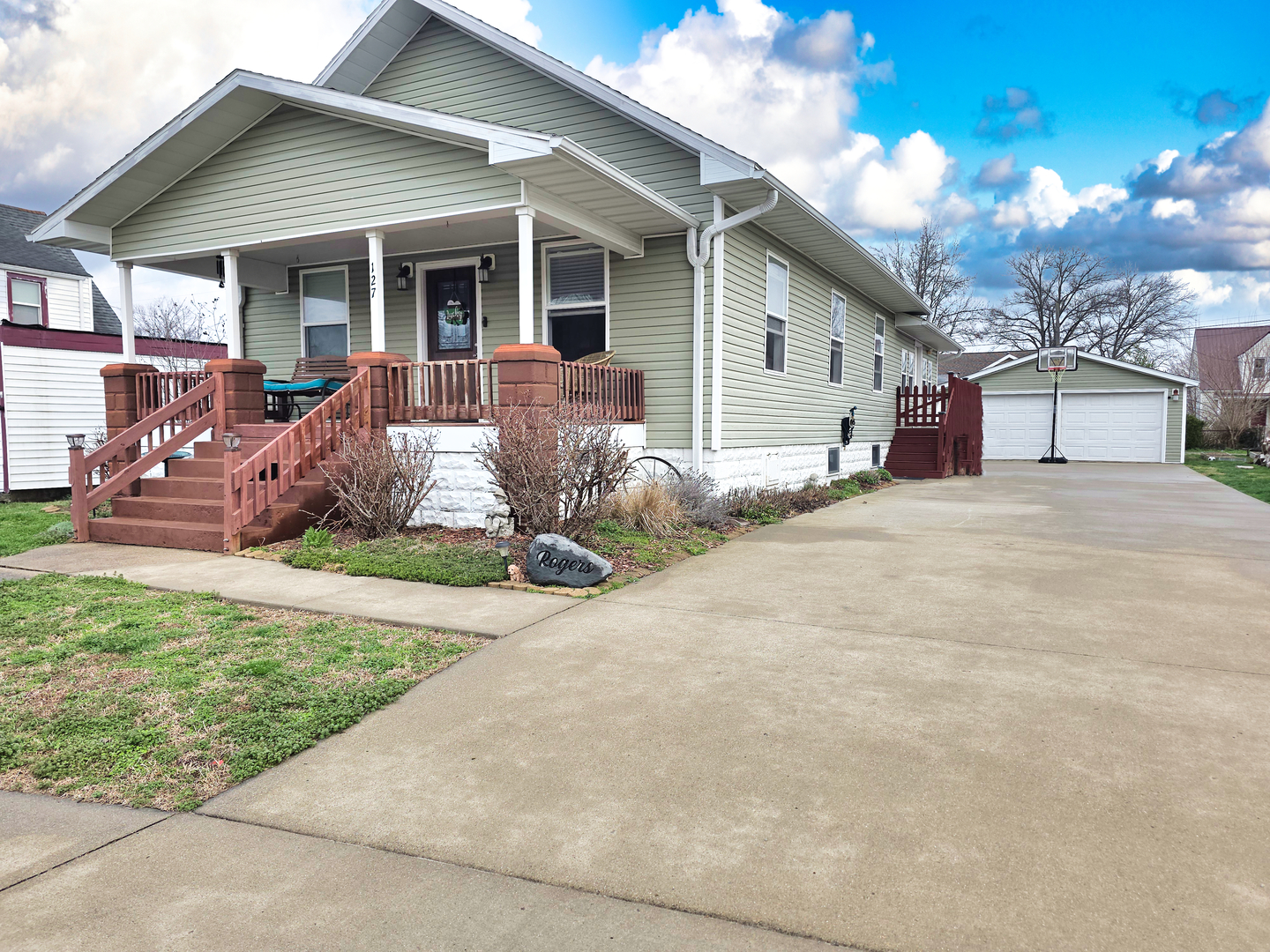 a front view of a house with a yard and outdoor seating