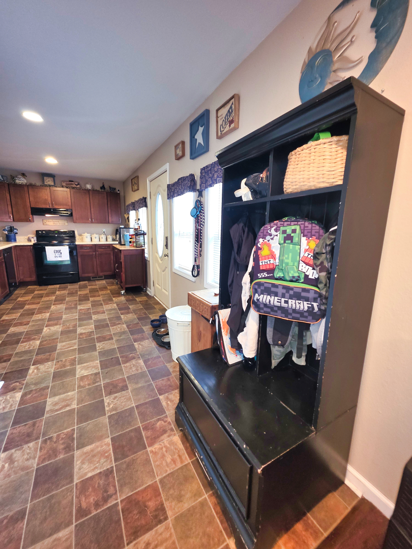 127 Flora Avenue Flora, IL 62839 - Photo 31 of 88 a living room with furniture a flat screen tv and a floor to ceiling window