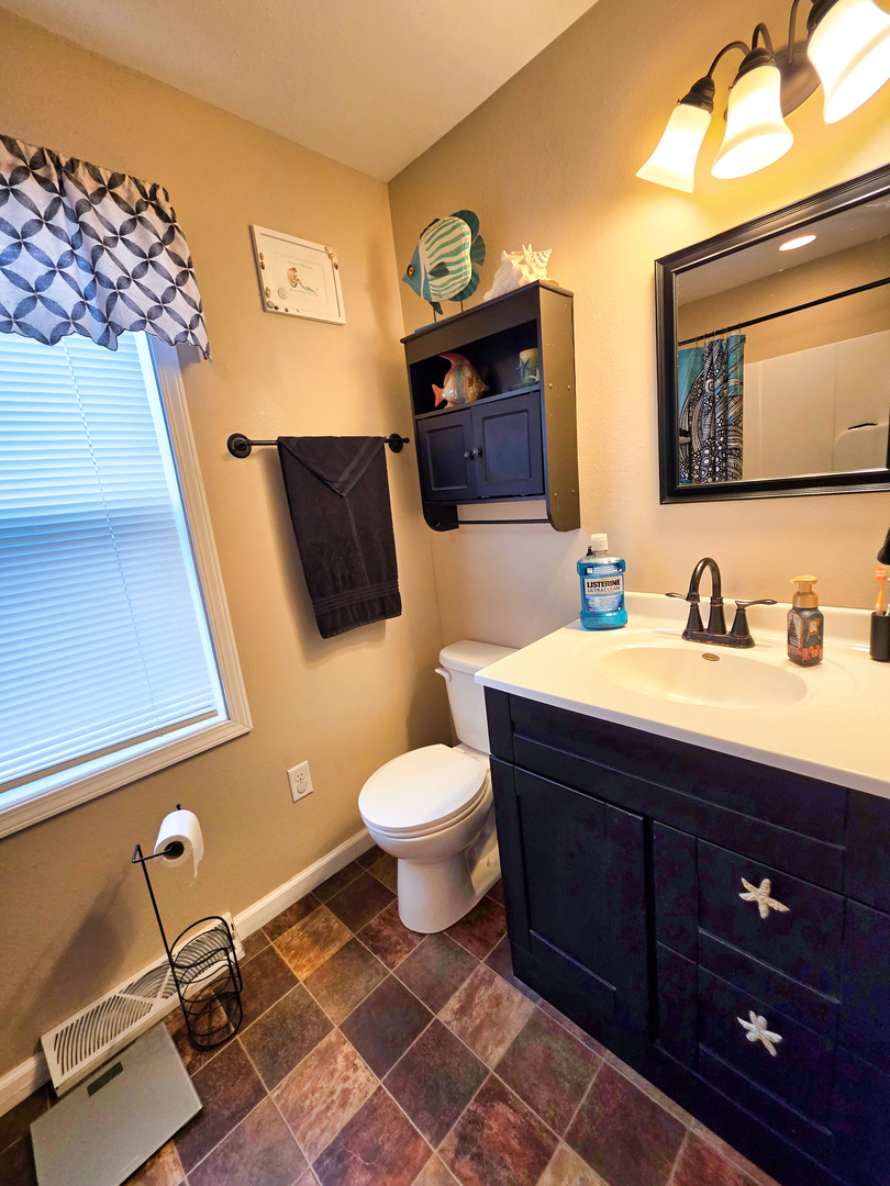 127 Flora Avenue Flora, IL 62839 - Photo 48 of 88 a bathroom with a toilet a sink and mirror