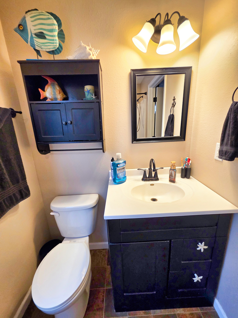 127 Flora Avenue Flora, IL 62839 - Photo 52 of 88 a bathroom with a toilet a sink and mirror