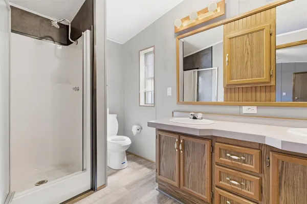 a bathroom with a sink toilet and shower