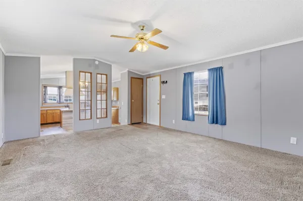 a view of a livingroom with a ceiling fan and window