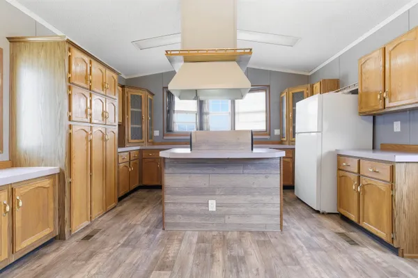 a kitchen with white cabinets and refrigerator