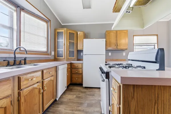 a kitchen with kitchen island a sink stove and refrigerator