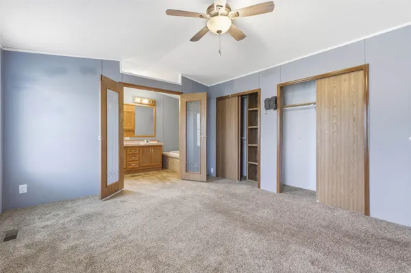 a view of a room with a ceiling fan and a bathroom