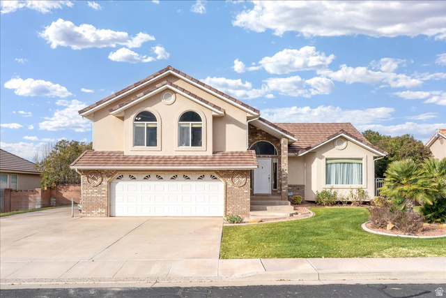 7 Reflection Way St. George, UT 84770 - Photo 2 of 54 Mediterranean / spanish-style home with a garage, driveway, stucco siding, and a front lawn