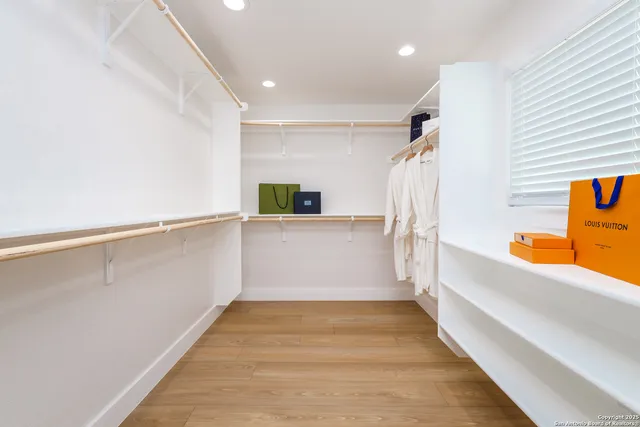 a view of a hallway with stairs and a closet