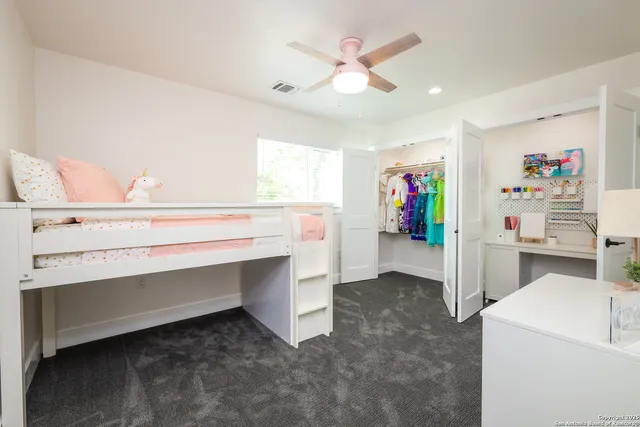 a blue bed sitting in a bedroom next to a window