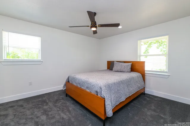a bathroom with a sink toilet a mirror and shower