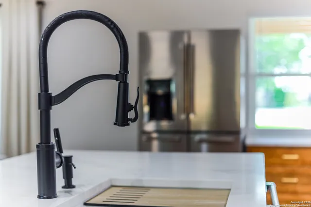 a kitchen with stainless steel appliances granite countertop a sink and cabinets