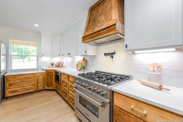 a kitchen with stainless steel appliances granite countertop a stove and a sink