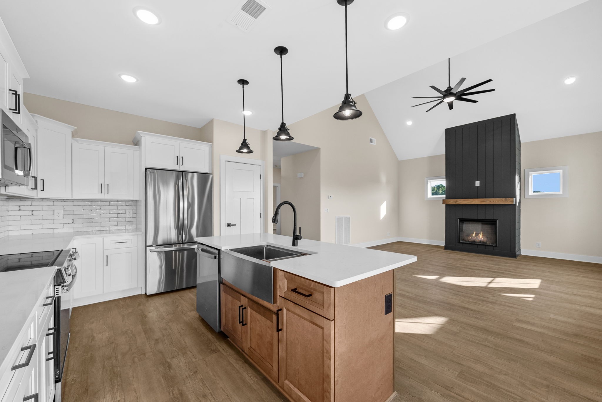 3860 Chapel Hill Road Clarksville, TN 37040 - Photo 11 of 38 a kitchen with refrigerator a stove a sink and a wooden floor