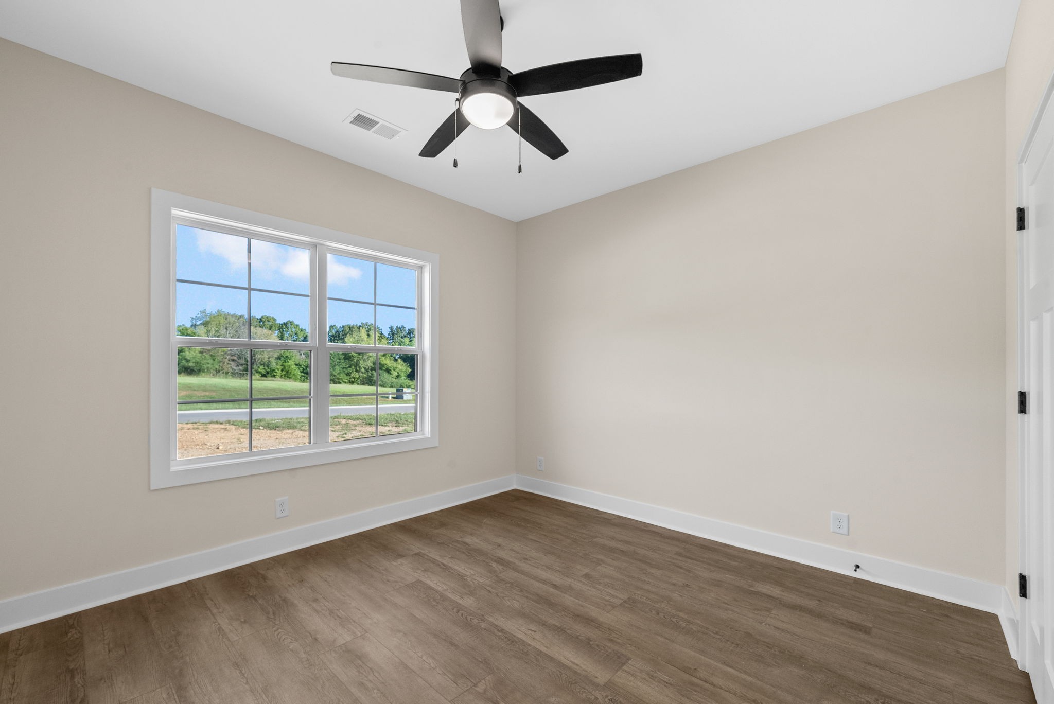 3860 Chapel Hill Road Clarksville, TN 37040 - Photo 23 of 38 an empty room with wooden floor ceiling fan and windows
