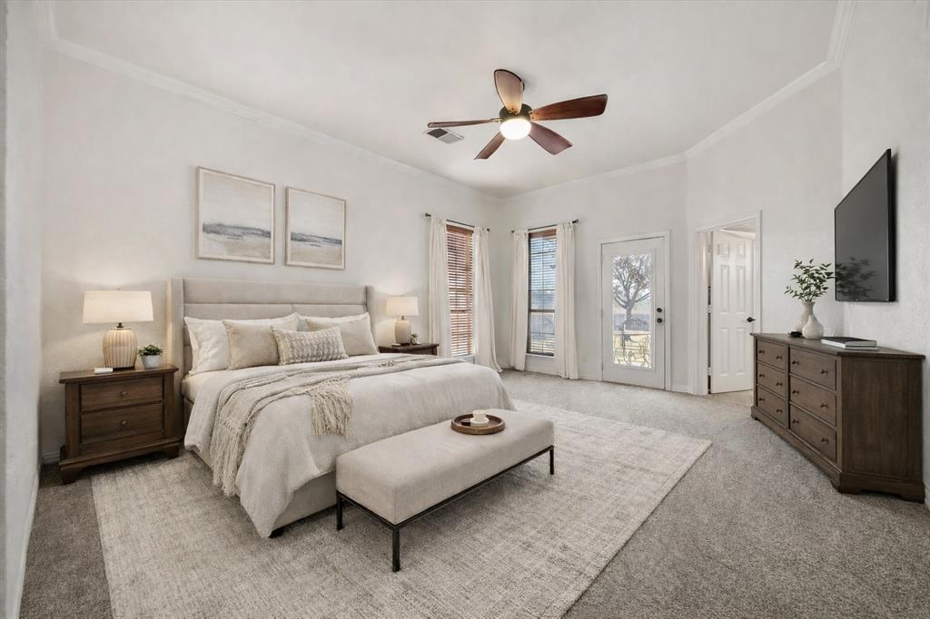 9398 Blarney Stone Way Forney, TX 75126 - Photo 16 of 38 a spacious bedroom with a bed and a flat screen tv