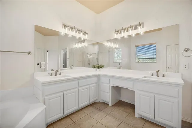 a spacious bathroom with a double vanity sink mirror and