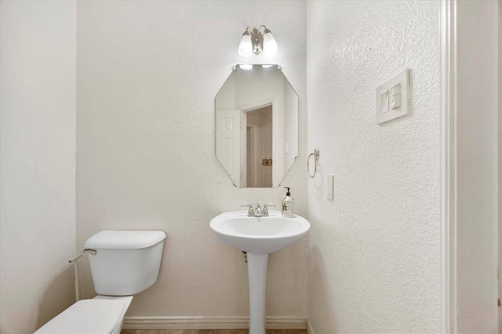 9398 Blarney Stone Way Forney, TX 75126 - Photo 22 of 38 a bathroom with a sink toilet and a mirror