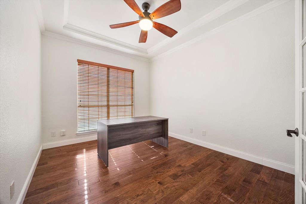 9398 Blarney Stone Way Forney, TX 75126 - Photo 23 of 38 an empty room with wooden floor and windows