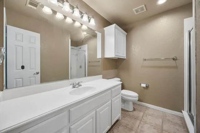 a bathroom with a sink toilet and mirror