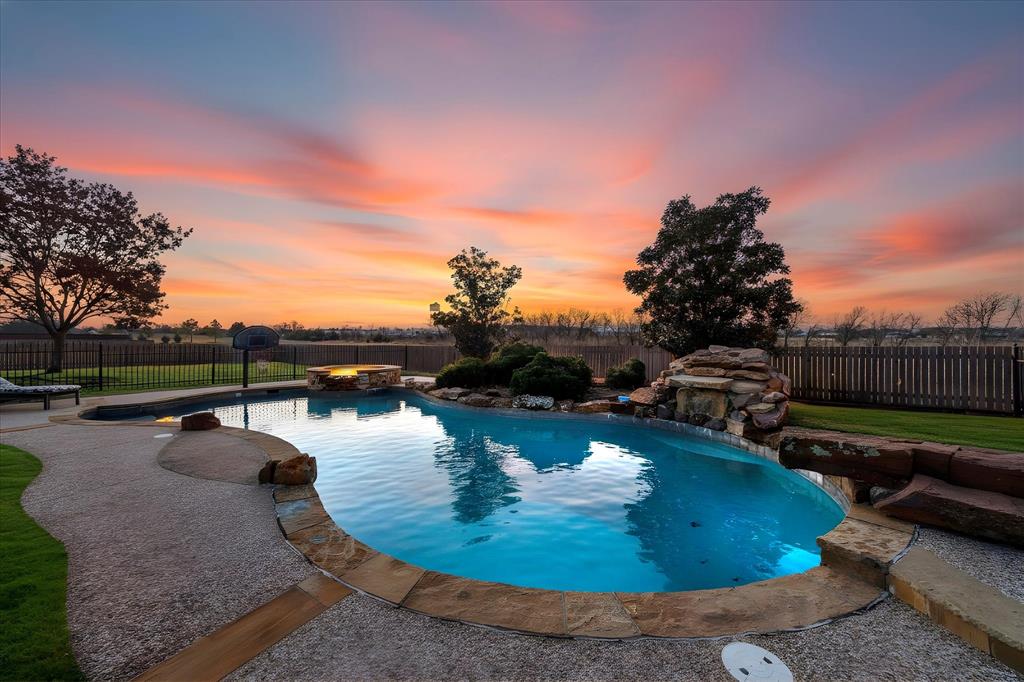9398 Blarney Stone Way Forney, TX 75126 - Photo 4 of 38 a view of a swimming pool with an outdoor seating and plants