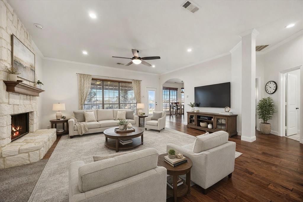 9398 Blarney Stone Way Forney, TX 75126 - Photo 9 of 38 a living room with furniture a flat screen tv and a fireplace