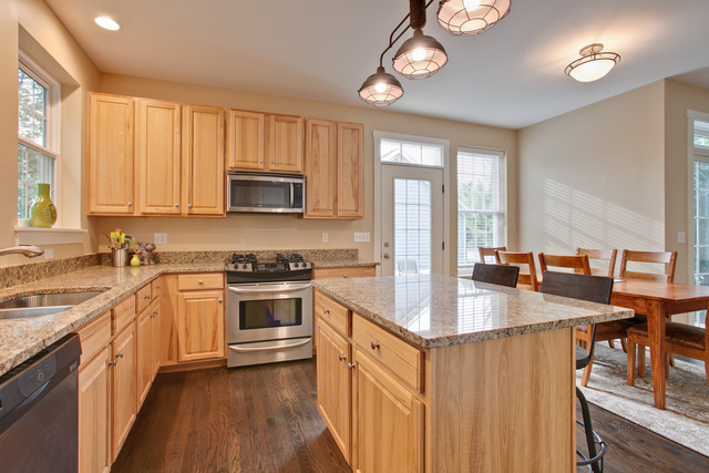 1405 Turks Cap Road Grayslake, IL 60030 - Photo 8 of 25 a kitchen with stainless steel appliances granite countertop a stove top oven a sink dishwasher and a microwave oven with cabinets