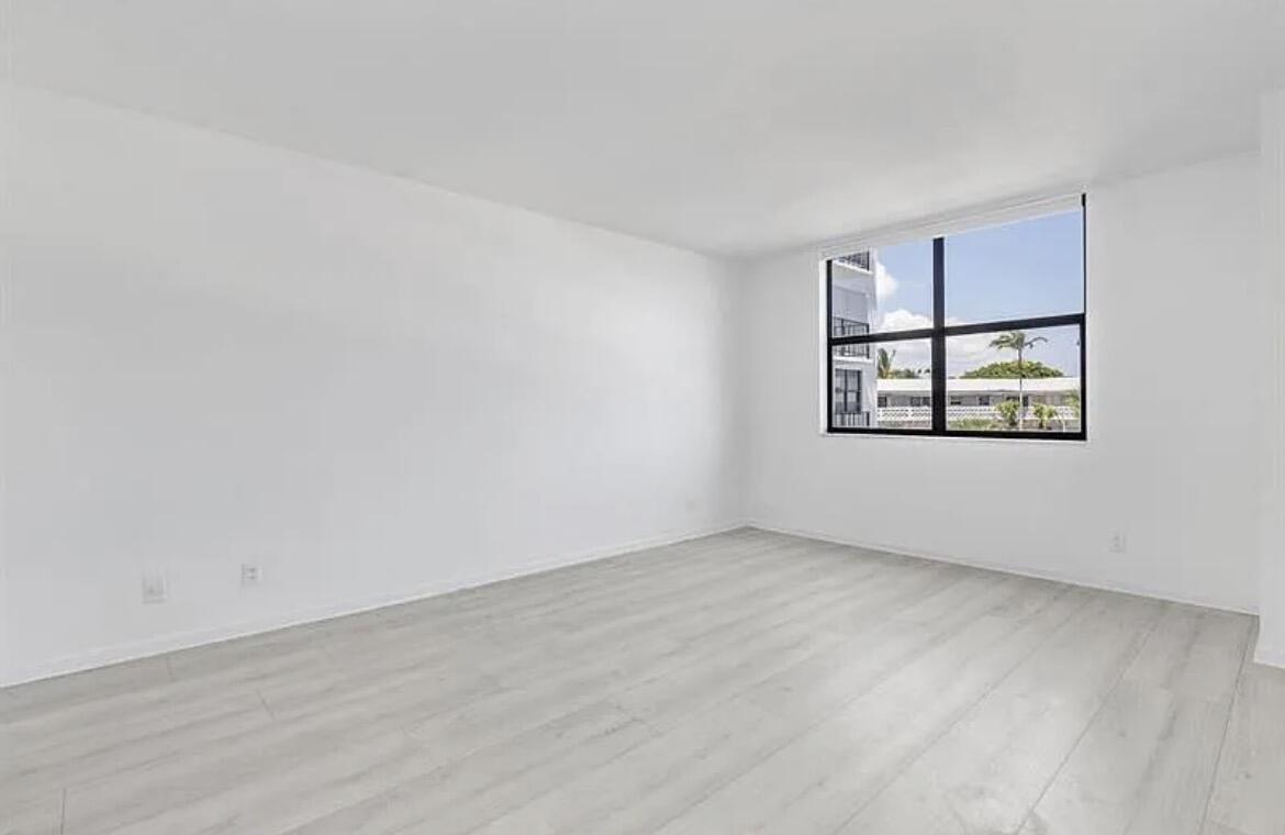 3800 Washington Road, Unit 310 West Palm Beach, FL 33405 - Photo 2 of 15 a view of an empty room with a window