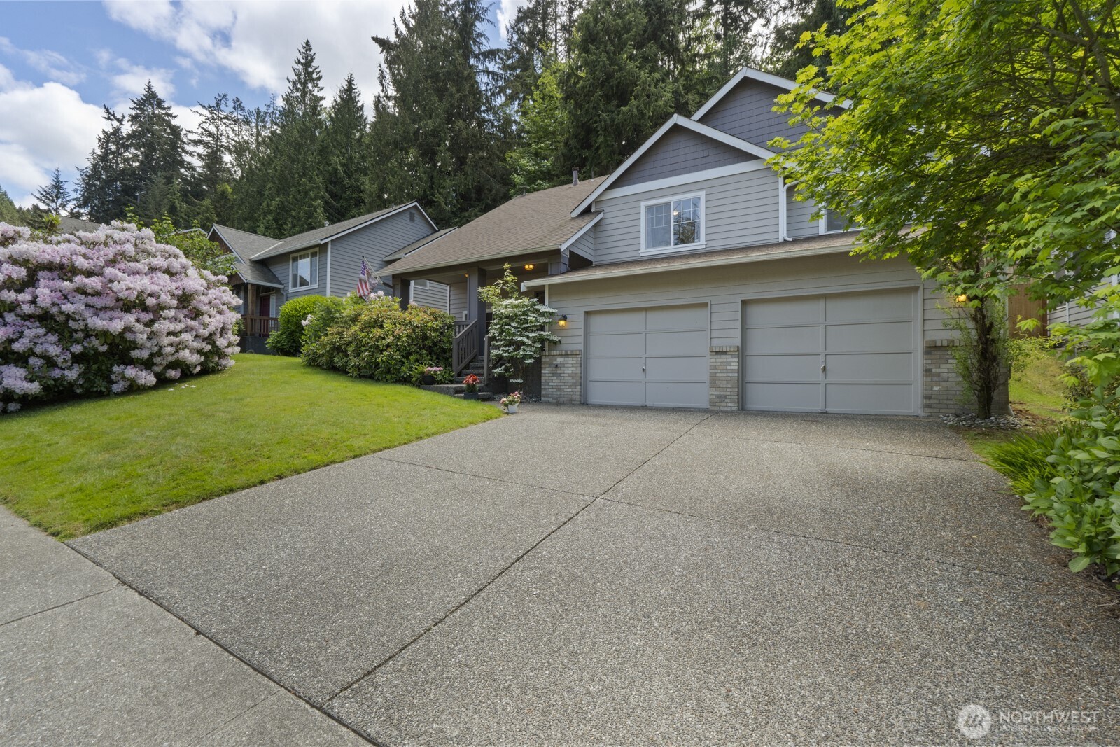 6108 133rd Place Southwest Edmonds, WA 98026 - Photo 2 of 40 a view of a house with a yard and garage