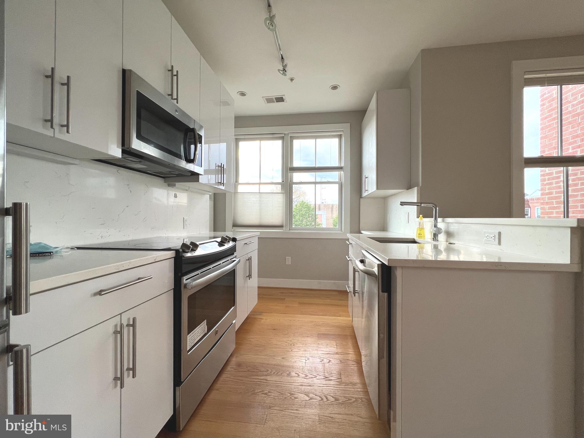1209 G Street Southeast, Unit 8 Washington, DC 20003 - Photo 18 of 27 a kitchen with stainless steel appliances granite countertop a sink and a stove